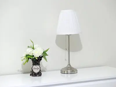 a lamp and a vase with flowers on a shelf at Vista Central in Colorado