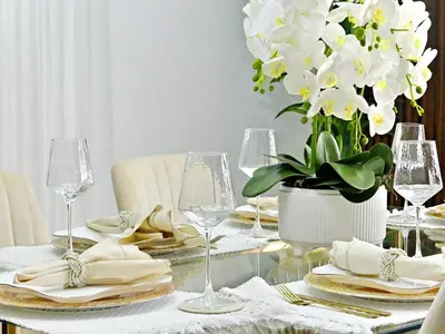 a dining room table with glasses and a vase of flowers at Casa Elegante in Colorado
