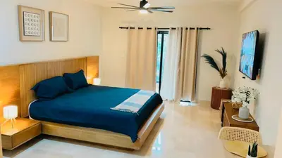 a bedroom with a blue bed in a room at Marien Residences 222 Gardenview Condo in Puerto Plata