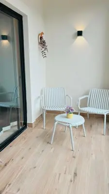 a room with two benches and a table and a window at Marien Residences 222 Gardenview Condo in Puerto Plata