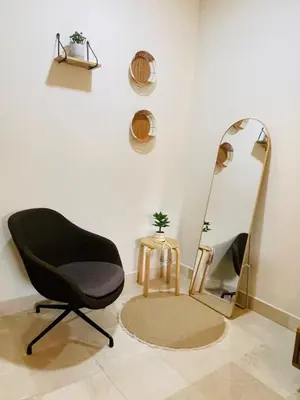 a room with a chair and a mirror at Marien Residences 222 Gardenview Condo in Puerto Plata