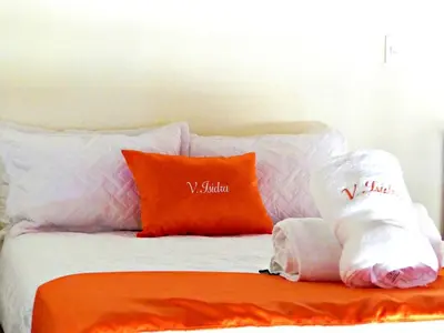 a bed with some pillows and towels on it at Luperon Cerca del Mar in Colorado