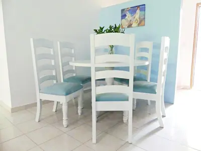 a white table and four chairs in a room at Cofresi, Puerto Plata in Colorado
