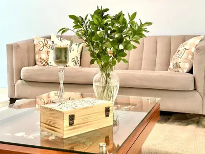 a vase with a plant on a glass table in a living room at Cofresi, Puerto Plata in Colorado