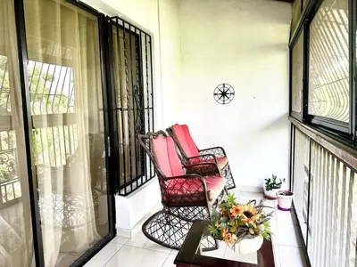 two rocking chairs sitting on a screened porch at Cofresi, Puerto Plata in Colorado