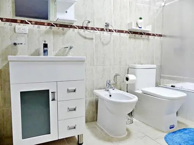 a white bathroom with a toilet and a sink at Cofresi, Puerto Plata in Colorado