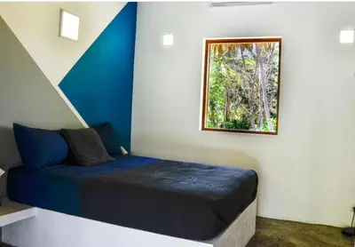 a bedroom with a blue bed and a window at Nomadas 5 bdrs villa with private pool 2nd line to beach in Las Terrenas