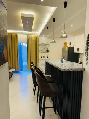 a kitchen with a bar with chairs and a counter top at Modern Apartment in Bayahibe in Bayahibe