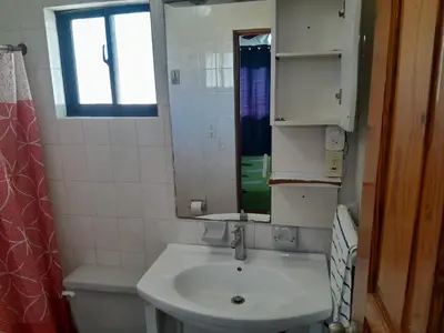 a bathroom with a sink and a mirror and a toilet at One bedroom apartment in the center with a pool in Sosúa