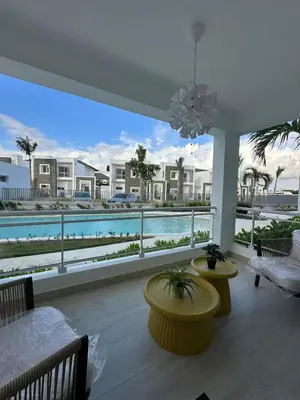 a living room with a view of a pool at Garden Breeze Ghibli-Pool View in La Laguna