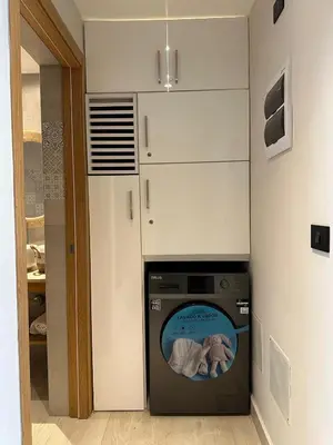a washer and dryer in a laundry room with at Garden Breeze Ghibli-Pool View in La Laguna