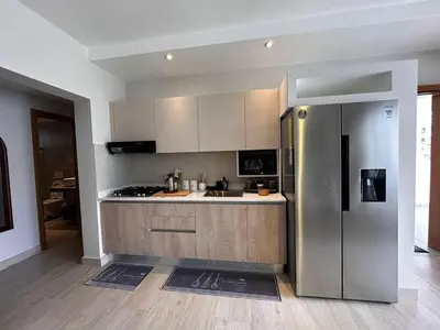 a kitchen with a stainless steel refrigerator at Garden Breeze Ghibli-Pool View in La Laguna