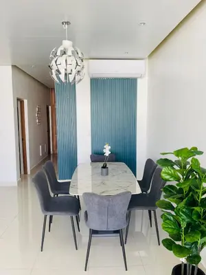 a dining room with a table and chairs and a chandelier at Sunset Residences 3BR, Pool & Beach Cosita Rica in Puerto Plata