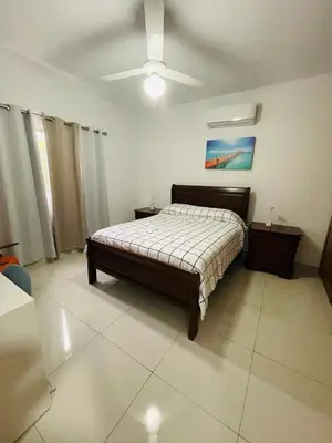 a bedroom with a bed and a ceiling fan at Oasis Residences, Modern 3BR Apartment with Pool in San Felipe de Puerto Plata