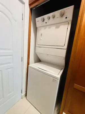 a white stove and refrigerator in a small kitchen at Oasis Residences, Modern 3BR Apartment with Pool in San Felipe de Puerto Plata