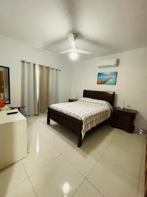 a bedroom with a bed and a ceiling fan at Oasis Residences, Modern 3BR Apartment with Pool in San Felipe de Puerto Plata