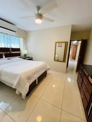 a bedroom with a bed and a ceiling fan at Modern 3BR with private pool near the beach in Puerto Plata