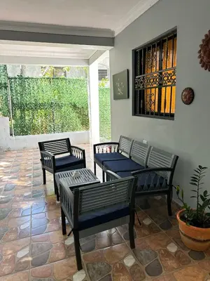 a patio with four chairs and a table at Modern and fully equipped house in Samaná in Santa Bárbara de Samaná
