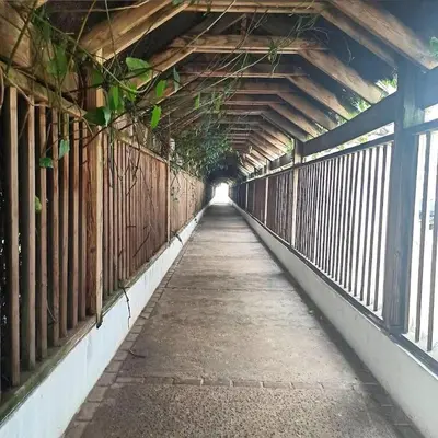 a walkway in a building with a bridge at Modern 2BR Condo Near the Beach Juan Dolio in Villas del Mar