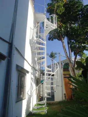 a white ladder on the side of a building at Waverider Apartments in Cabarete