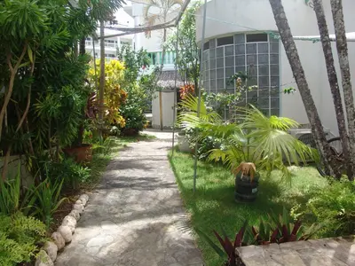 a garden with a walkway in front of a building at Waverider Apartments in Cabarete
