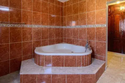a bathroom with a tub in a tiled wall at 4BR Villa Newly Renovated-5 min to Playa Dorada H1 in San Felipe de Puerto Plata
