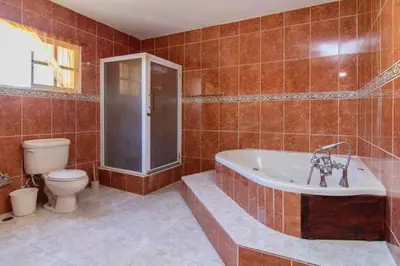 a bathroom with a tub and a toilet and a shower at 4BR Villa Newly Renovated-5 min to Playa Dorada H1 in San Felipe de Puerto Plata