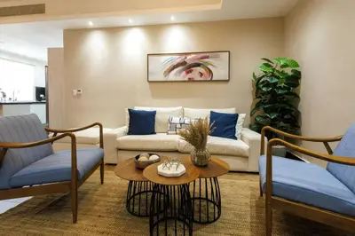 a living room with a couch and two chairs and a table at Upscale City Center Condo, Pool, Gym in Santo Domingo
