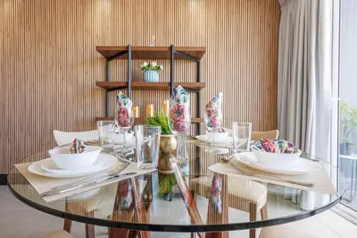 a dining room with a glass table and chairs at Upscale City Center Condo, Pool, Gym in Santo Domingo