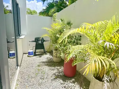 a patio with potted plants and a table in a building at Villa Hazel in Las Terrenas