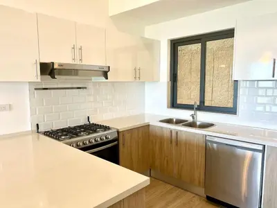 a white kitchen with a stove and a sink at Chic 2BR Apt 1km from Playa Bonita in Las Terrenas