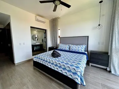 a bedroom with a bed and a ceiling fan at Chic 2BR Apt 1km from Playa Bonita in Las Terrenas