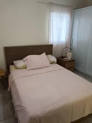 a bedroom with a white bed and a window at Jolie maison in La Romana
