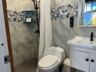 a bathroom with a toilet and a sink at Guest-House Caracol 2- 4 Pax, vista al mar in Las Galeras