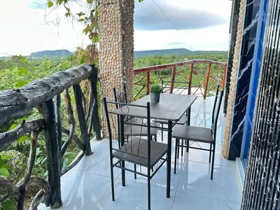 a table and chairs on the balcony of a house at Guest-House Caracol 2- 4 Pax, vista al mar in Las Galeras
