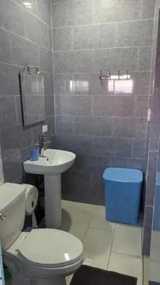 a bathroom with a white toilet and a sink at Mitaly apartamentos Santo Domingo G in Santo Domingo