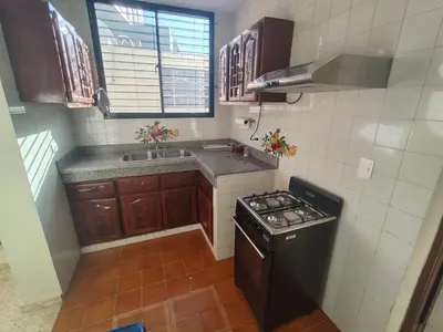 a small kitchen with a stove and a sink at Double room with private bathroom in Santo Domingo