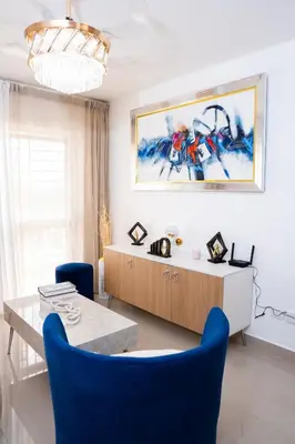 a dining room with blue chairs and a table at apartamento vacacional BANI in Boca Canasta