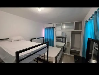 a bedroom with two bunk beds and blue curtains at villa fortuna in Nagua