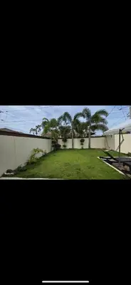 a view of a yard with trees and a building at villa fortuna in Nagua
