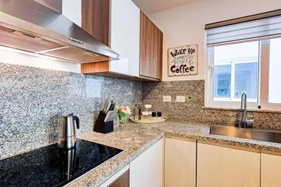 a kitchen with a sink and a counter top at Elegant 2BR Apt, Steps to Hard Rock in Punta Cana