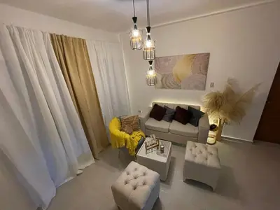 a living room with a couch and chairs at Modern 3-bedroom apartment in a gated residential community in Concepción de La Vega
