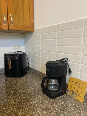 a coffee maker sitting on top of a kitchen counter at Modern 3-bedroom apartment in a gated residential community in Concepción de La Vega