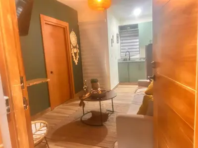 a living room with a couch and a table at El descanso in Higuey