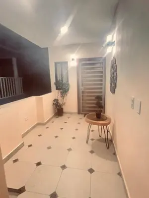 a hallway with a table and a floor at El descanso in Higuey