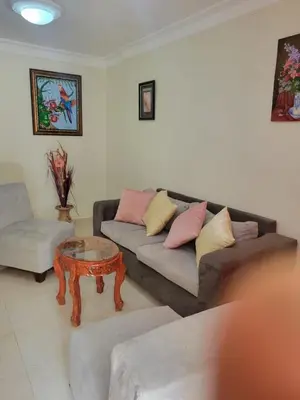 a living room with a couch and a coffee table at Spacious house with private parking in San Felipe de Puerto Plata