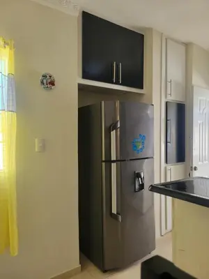 a kitchen with a stainless steel refrigerator and cabinets at Spacious house with private parking in San Felipe de Puerto Plata