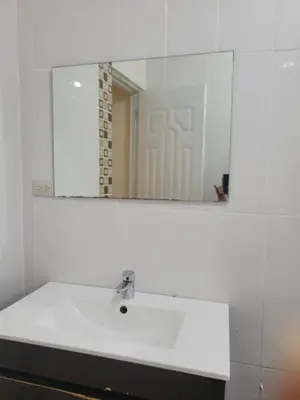 a bathroom with a white sink and a mirror at Spacious house with private parking in San Felipe de Puerto Plata
