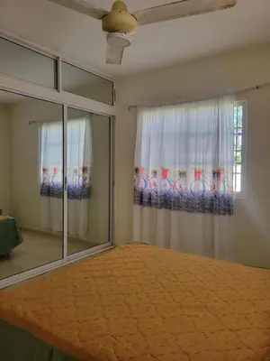 a bedroom with a bed and a window at Spacious house with private parking in San Felipe de Puerto Plata