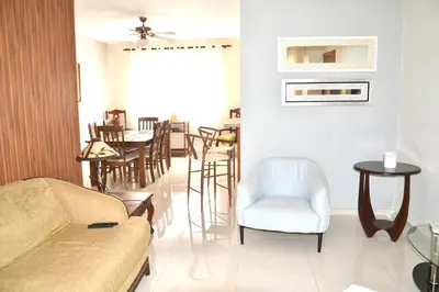 a living room with a couch and a table and chairs at Comfortable Apartment, Torre Alta in San Felipe de Puerto Plata